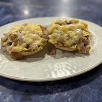 Two open-face English muffin melts with ham and cheese at Bonnie's