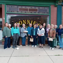 Staff and supporters group photo in front of Bonnie's storefront